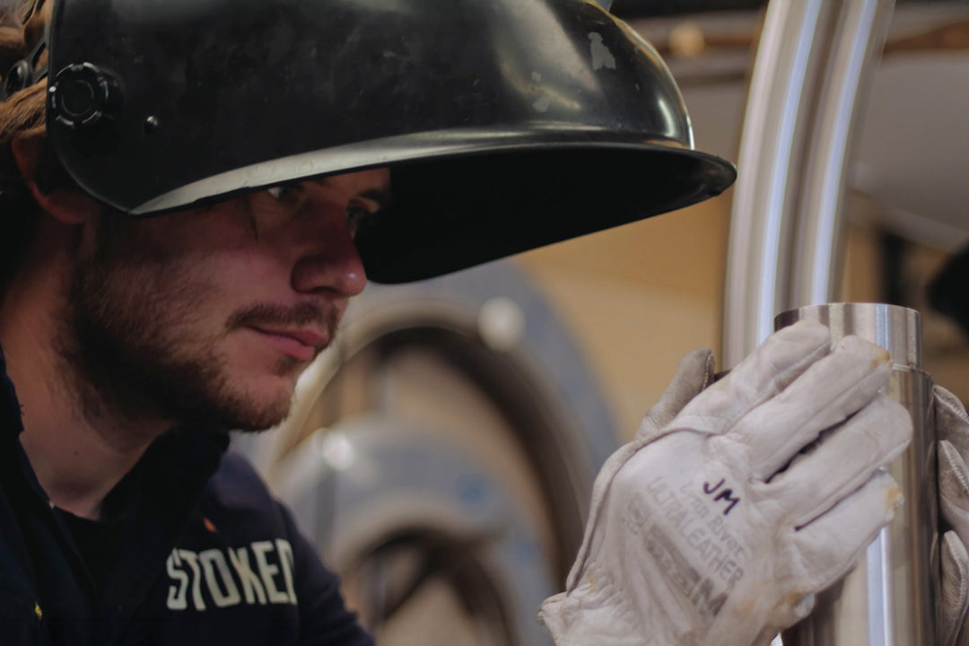 Craftsman handcrafting stainless steel hot tub in New Zealand workshop