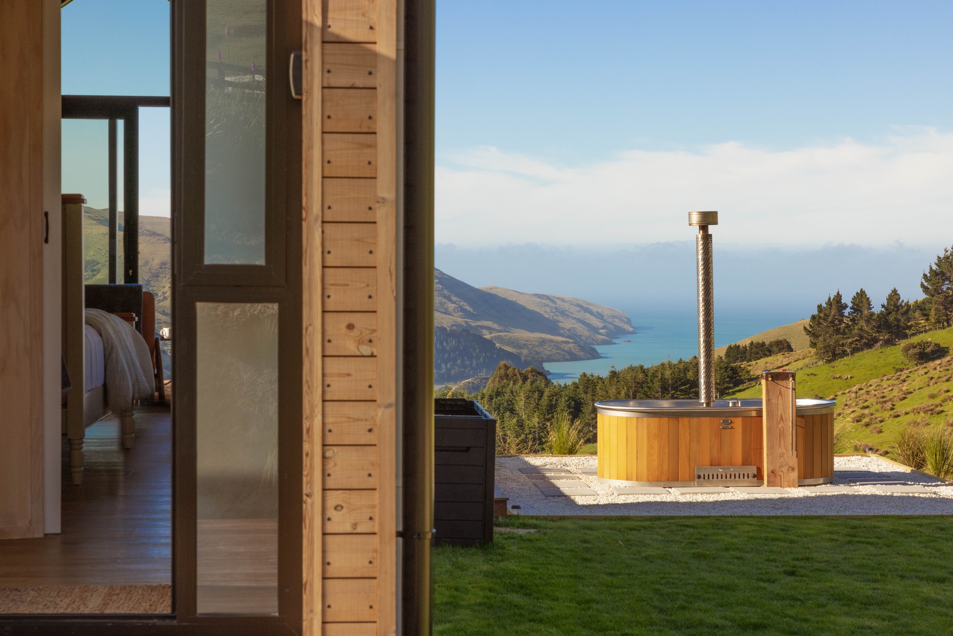 Stoked cedar bath overlooking the New Zealand mountains